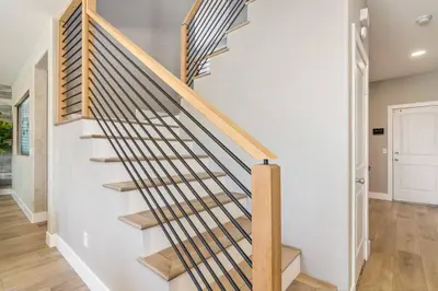 a wooden staircase in a home with white walls at The Lake Stay in Menifee