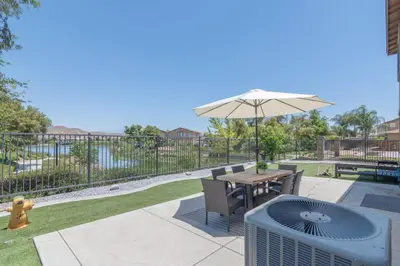 a patio with a table and an umbrella and a fire hydrant at The Lake Stay in Menifee