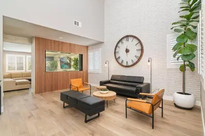 a living room with a couch and a clock at The Lake Stay in Menifee