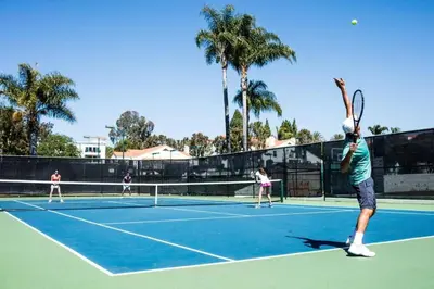a group of people playing tennis on a tennis court at Luxury Villa at Omni La Costa Resort & Spa in Carlsbad
