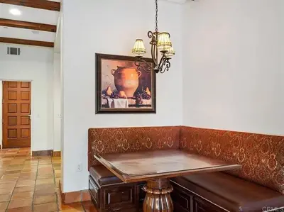 a dining room table with a bench and a picture on the wall at Luxury Villa at Omni La Costa Resort & Spa in Carlsbad