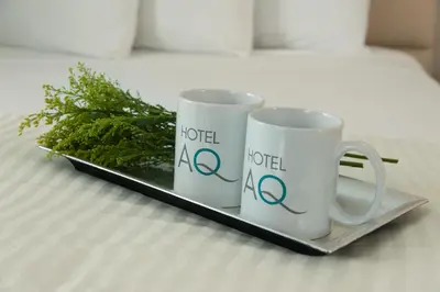 two coffee mugs sitting on a tray on a bed at Hotel Aqua Mar in San Diego