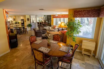 a dining room and living room with a table and chairs at Poolside Splendor! Spacious De Anza Golf Club Home in Borrego Springs