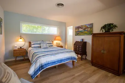 a bedroom with a bed and a dresser and a window at Poolside Splendor! Spacious De Anza Golf Club Home in Borrego Springs
