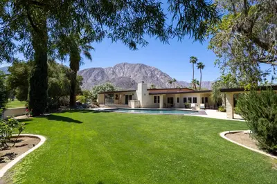 a house with a pool and mountains in the background at Poolside Splendor! Spacious De Anza Golf Club Home in Borrego Springs