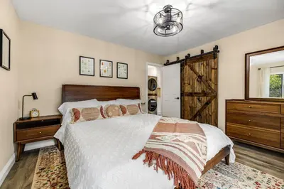 a bedroom with a bed and a dresser and a window at Buckthorn Beauty Private Hot Tub and Lounge Space in Pine Valley
