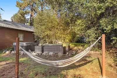 a hammock in a yard in front of a house at Buckthorn Beauty Private Hot Tub and Lounge Space in Pine Valley