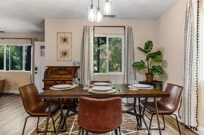 a dining room with a table and chairs at Buckthorn Beauty Private Hot Tub and Lounge Space in Pine Valley