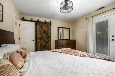 a bedroom with a large bed and a window at Buckthorn Beauty Private Hot Tub and Lounge Space in Pine Valley