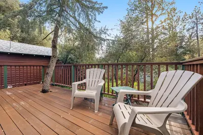 two chairs and a table on a deck at Buckthorn Beauty Private Hot Tub and Lounge Space in Pine Valley
