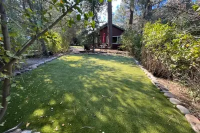 a large yard with a house in the background at Buckthorn Beauty Private Hot Tub and Lounge Space in Pine Valley