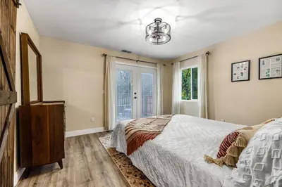 a bedroom with a bed and a window at Buckthorn Beauty Private Hot Tub and Lounge Space in Pine Valley