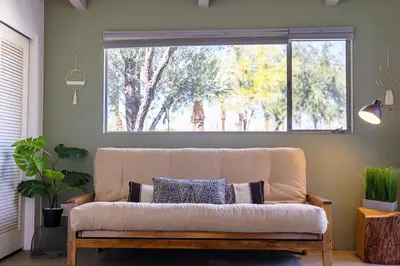 a couch in a living room with a large window at Pool and Mtn View! Designer Borrego Springs Hideaway in Borrego Springs
