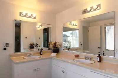 a bathroom with two sinks and two mirrors at Pool and Mtn View! Designer Borrego Springs Hideaway in Borrego Springs