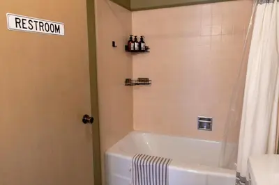 a bathroom with a tub and a sign that reads restroom at Pool and Mtn View! Designer Borrego Springs Hideaway in Borrego Springs
