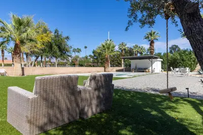 two wicker chairs sitting on the grass in a park at Pool and Mtn View! Designer Borrego Springs Hideaway in Borrego Springs