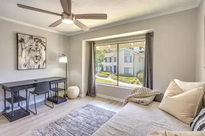a living room with a couch and a desk at Laguna Niguel Townhouse with Community Pool Access! in Laguna Niguel