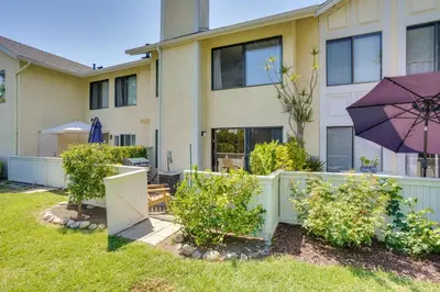 a house with a purple umbrella in the yard at Laguna Niguel Townhouse with Community Pool Access! in Laguna Niguel