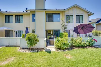 a house with an umbrella in a yard at Laguna Niguel Townhouse with Community Pool Access! in Laguna Niguel