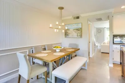 a kitchen and dining room with a table and chairs at Laguna Niguel Townhouse with Community Pool Access! in Laguna Niguel
