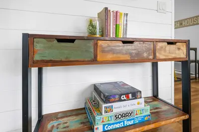 a wooden shelf with books on it next to a wall at Beach-2-Bay 1br - Mission Beach - AC - Shops in San Diego
