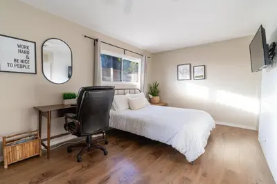 a bedroom with a bed and a desk and a chair at 4Bd, Family Friendly, Fun Yard, Close to Beaches! in Oceanside