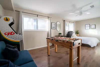 a living room with a foosball table and a bed at 4Bd, Family Friendly, Fun Yard, Close to Beaches! in Oceanside