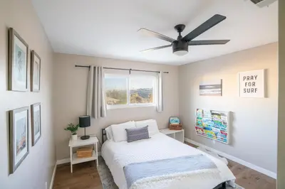 a bedroom with a bed and a ceiling fan at 4Bd, Family Friendly, Fun Yard, Close to Beaches! in Oceanside