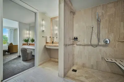 a bathroom with a shower and a sink at Pendry Newport Beach in Newport Beach