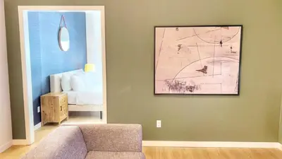 a living room with a couch and a painting on the wall at Ambient Oasis in the Heart of San Diego in San Diego