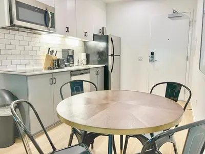 a kitchen with a table and chairs in a kitchen at Ambient Oasis in the Heart of San Diego in San Diego