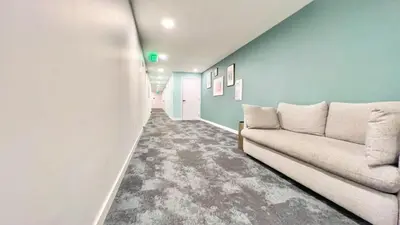 a living room with a couch and blue walls at Ambient Oasis in the Heart of San Diego in San Diego