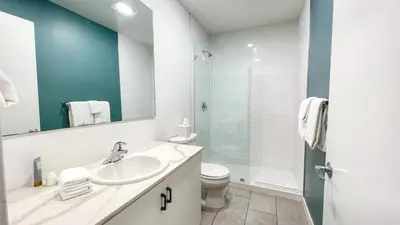 a bathroom with a sink and a toilet and a mirror at Ambient Oasis in the Heart of San Diego in San Diego