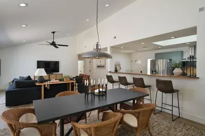 a dining room and living room with a table and chairs at Coastal Retreat with E-Bikes! in Carlsbad
