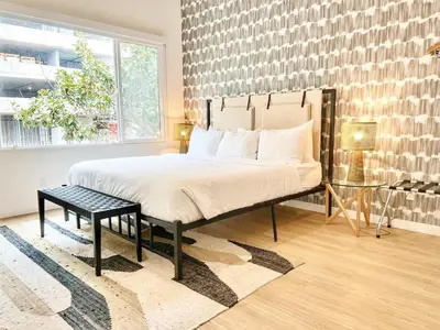 a bedroom with a large bed and a large window at Cozy Couple's Corner in Downtown San Diego in San Diego