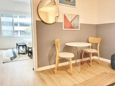 a table and chairs in a room with a mirror at Cozy Couple's Corner in Downtown San Diego in San Diego