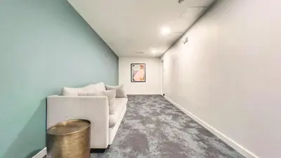 a living room with a white couch and blue walls at Cozy Couple's Corner in Downtown San Diego in San Diego