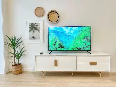 a flat screen tv sitting on top of a white cabinet at Executive Escape in Downtown San Diego in San Diego