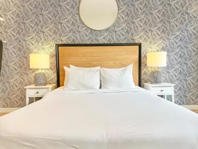 a bedroom with a large white bed with two lamps at Fabulous Urban Retreat in San Diego in San Diego