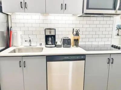 a kitchen with white cabinets and a sink at Fabulous Urban Retreat in San Diego in San Diego