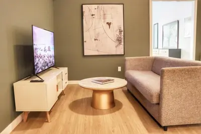 a living room with a couch and a table at Dapper Retreat in Vibrant San Diego in San Diego