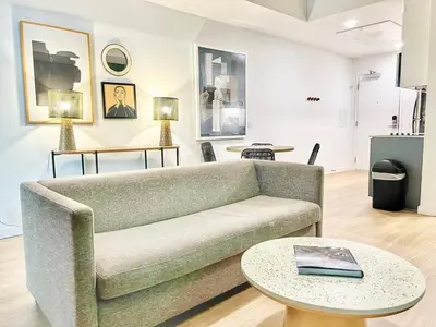 a living room with a couch and a table at Dapper Retreat in Vibrant San Diego in San Diego