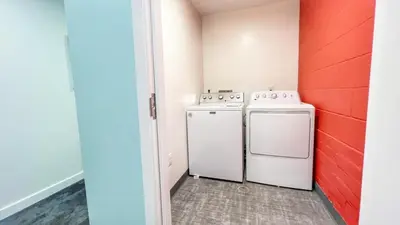 a laundry room with a washer and dryer at Grand Downtown San Diego Apartment in San Diego