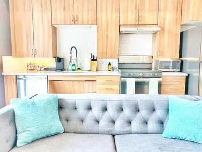 a kitchen with a couch in the middle of a kitchen at The Leo - Unit 602 in San Diego
