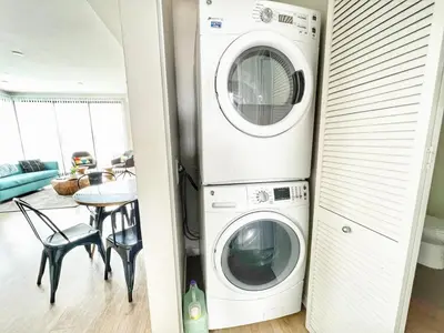 a laundry room with a washer and dryer at 3 Bedroom Penthouse in Downtown! in San Diego