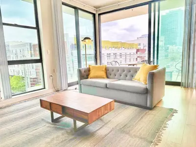 a living room with a couch and a coffee table at One Bedroom Apartment wBalcony and City Views! in San Diego
