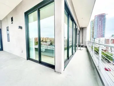 an empty balcony with large windows in a building at The Leo - Deluxe 3 Bedroom Stay in San Diego