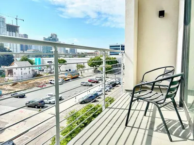 a chair on a balcony with a view of a highway at Hidden Gem Apartment in Downtown in San Diego