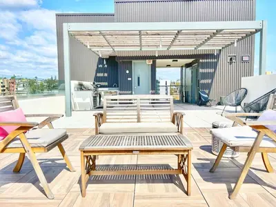 a patio with benches and chairs on a building at Hidden Gem Apartment in Downtown in San Diego