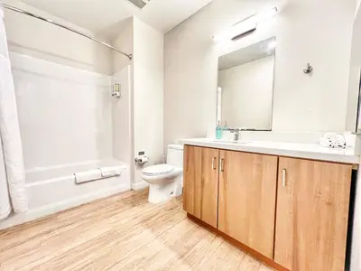 a bathroom with a sink toilet and a mirror at Hidden Gem Apartment in Downtown in San Diego